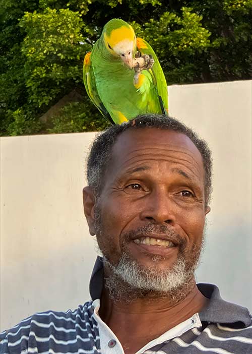 Gibi Coffie, with a Yellow-shouldered Amazon.